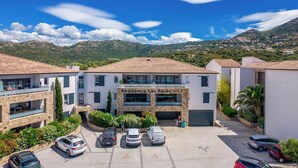 A building named 'Residence Les Alizes' with a parking lot and surrounding greenery. - Les Alizés Résidence & Spa  (Monticello)