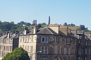 A historic building with multiple stories, stone facade, and a prominent tower.