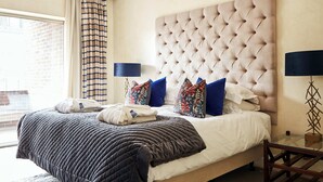 A hotel room with a large bed, a glass coffee table, and a view of the outside. - 9 Hertford Street Mayfair (London)