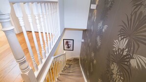 A staircase with white balusters and a carpeted landing. - Contemporary 1 Bedroom Flat in Fulham near The Thames (London)