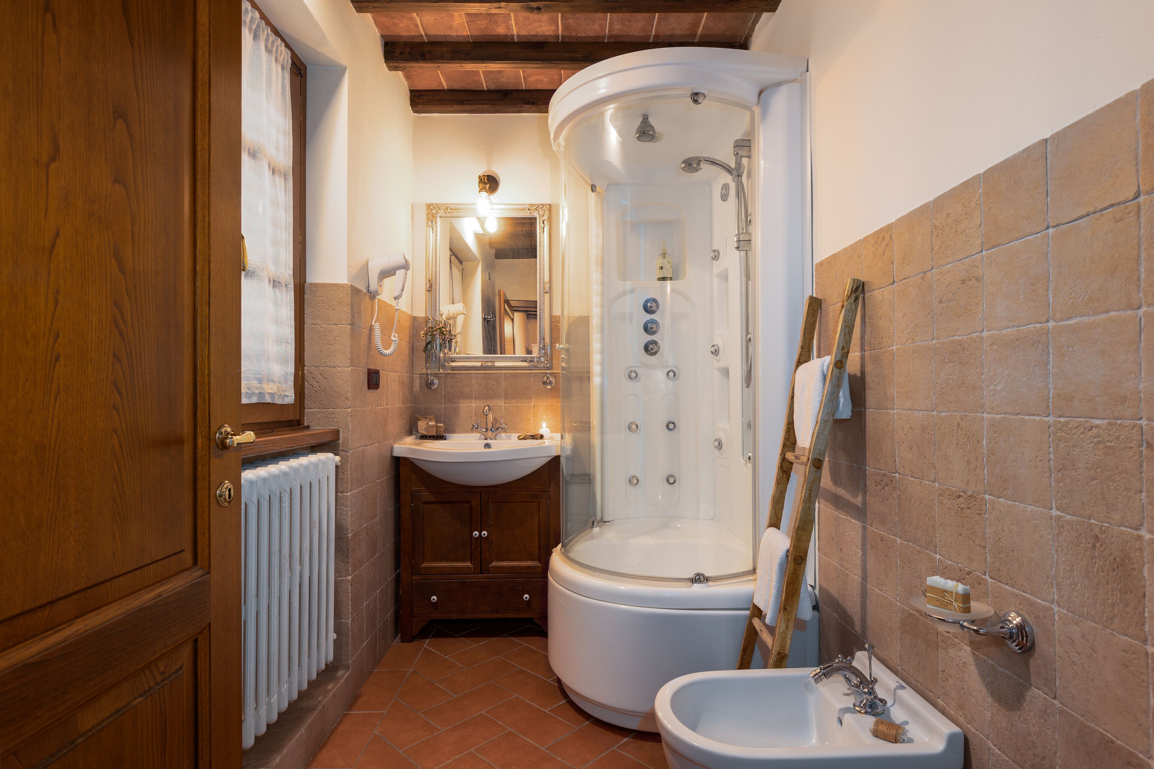 A bathroom with a shower, sink, and toilet.
