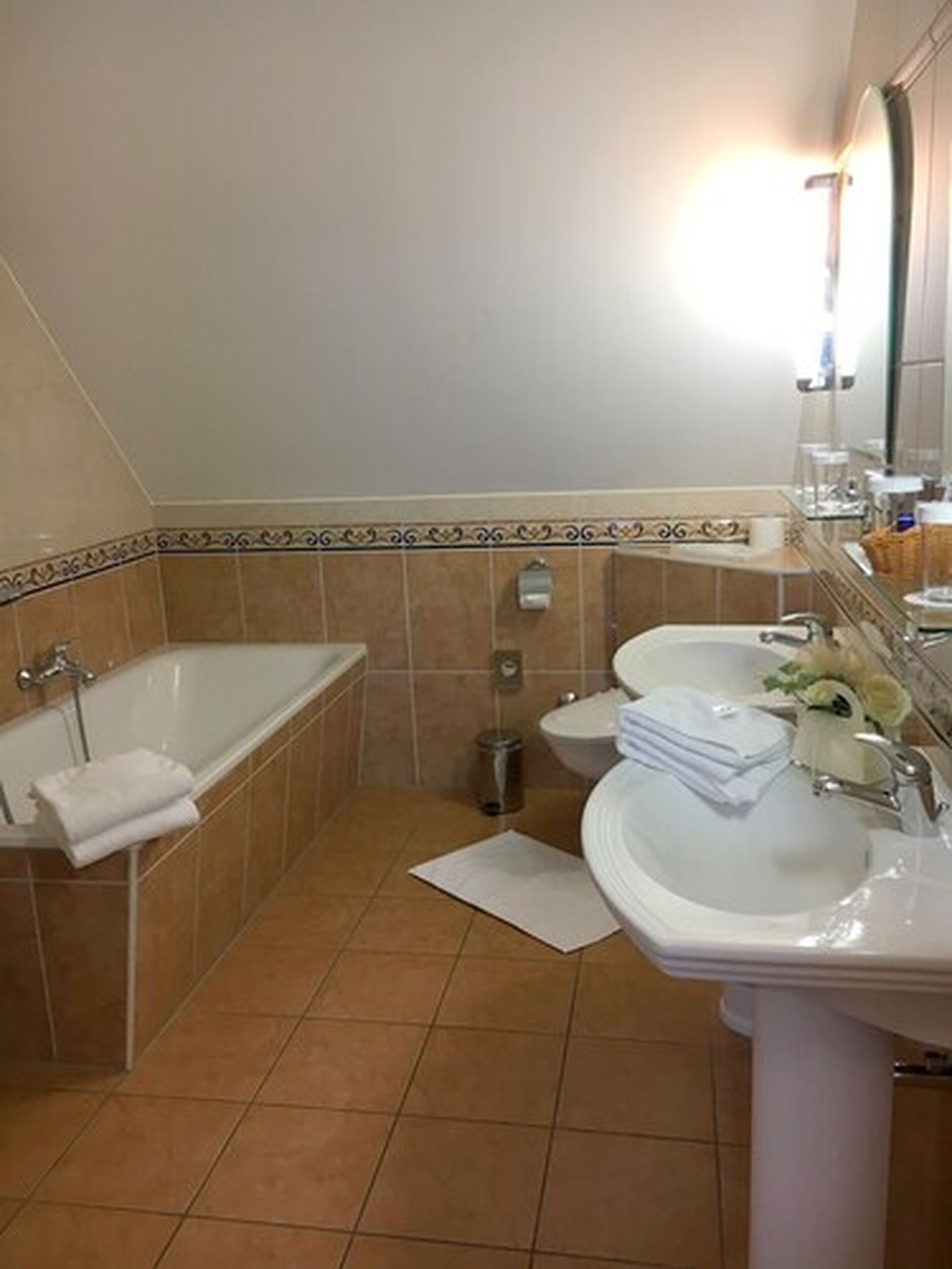 A bathroom with a bathtub, a sink, and a toilet.