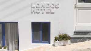 A building with a sign reading "Londos Hotel". - Londos (Paros)