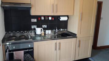 Fridge, microwave, electric kettle, cookware/dishes/utensils