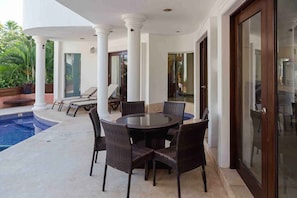 Vila com design assinado, piscina particular, vista parcial para o oceano | Terraço/pátio