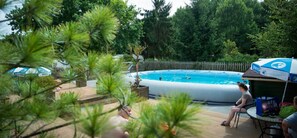 Una piscina al aire libre de temporada, sombrillas