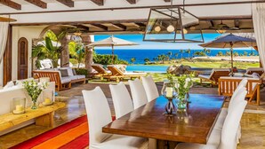 A dining area with a view of the ocean, outdoor seating, and a pool. - Casa Mar by Cabo Platinum (Cabo San Lucas)