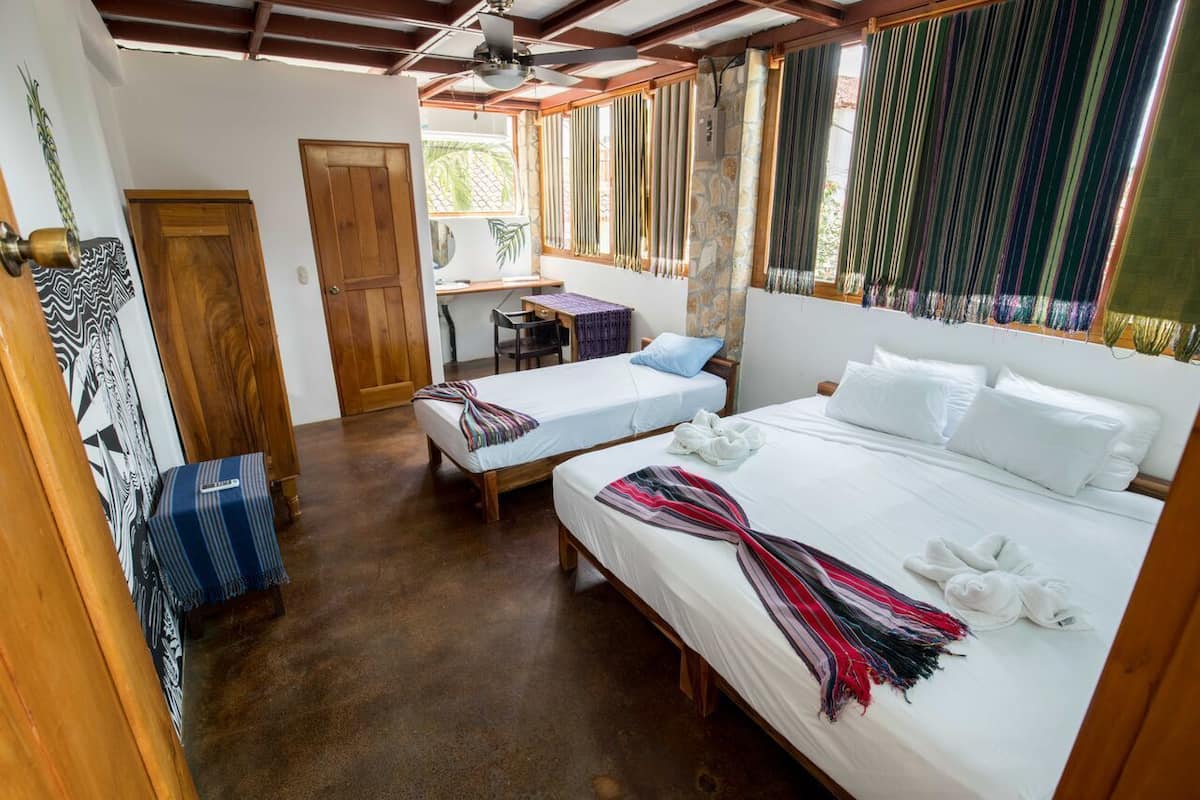 Deluxe Triple Room, 1 Bedroom, Private Bathroom, Partial Ocean View | 1 bedroom, individually decorated, individually furnished, desk