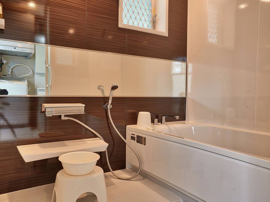 A modern bathroom with a large bathtub, a toilet, and a sink.