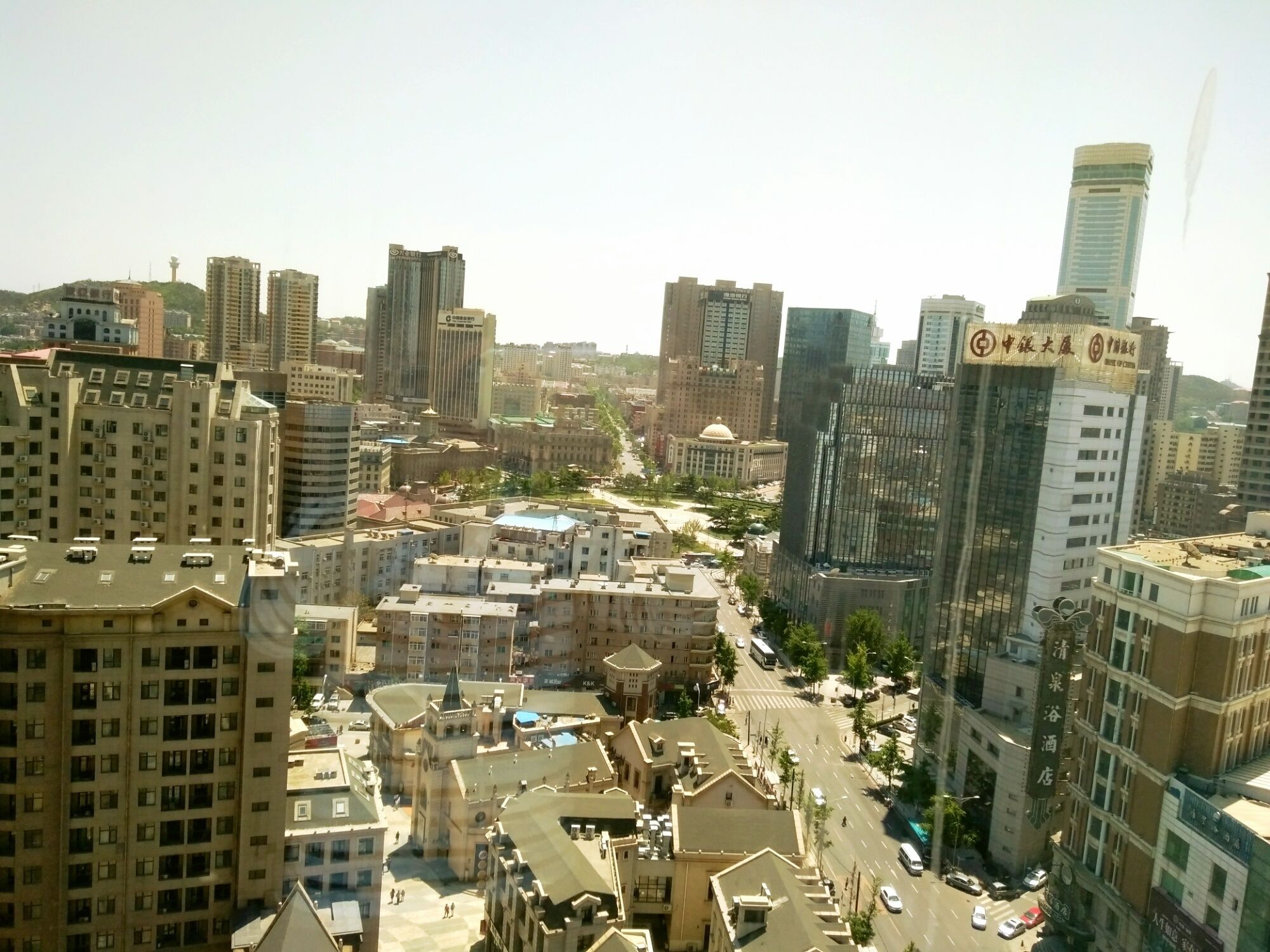 A cityscape with various buildings, including a hotel with a sign indicating it is a hotel.