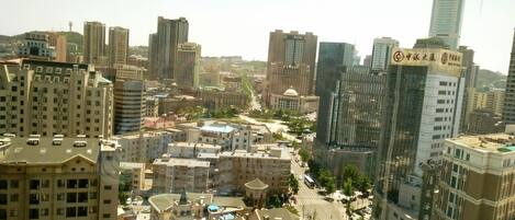 A cityscape with various buildings, including a hotel with a sign indicating it is a hotel.