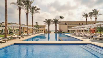Outdoor pool, open 8:00 AM to 6:00 PM, pool umbrellas
