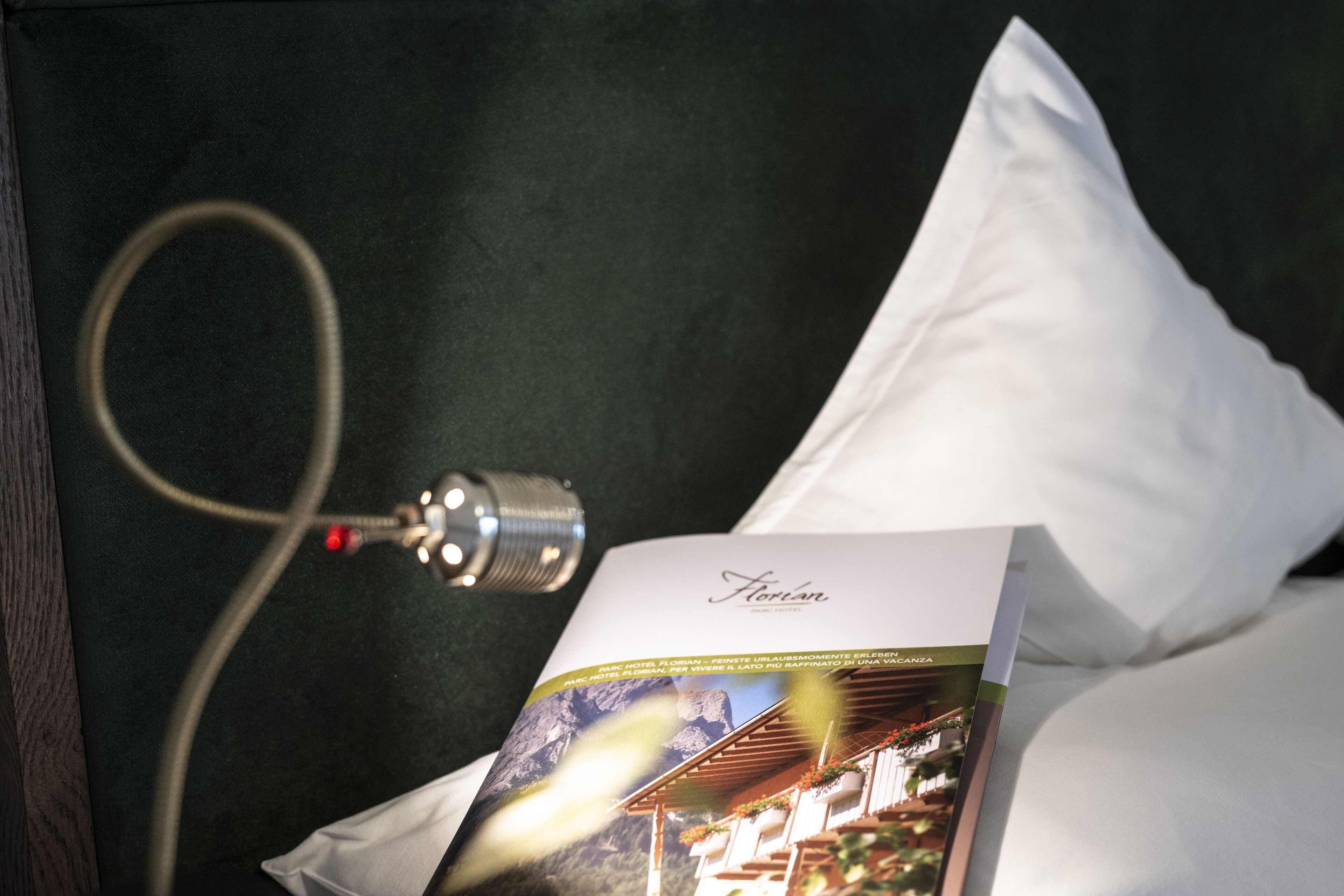 A pillow with a brochure and a microphone cable.