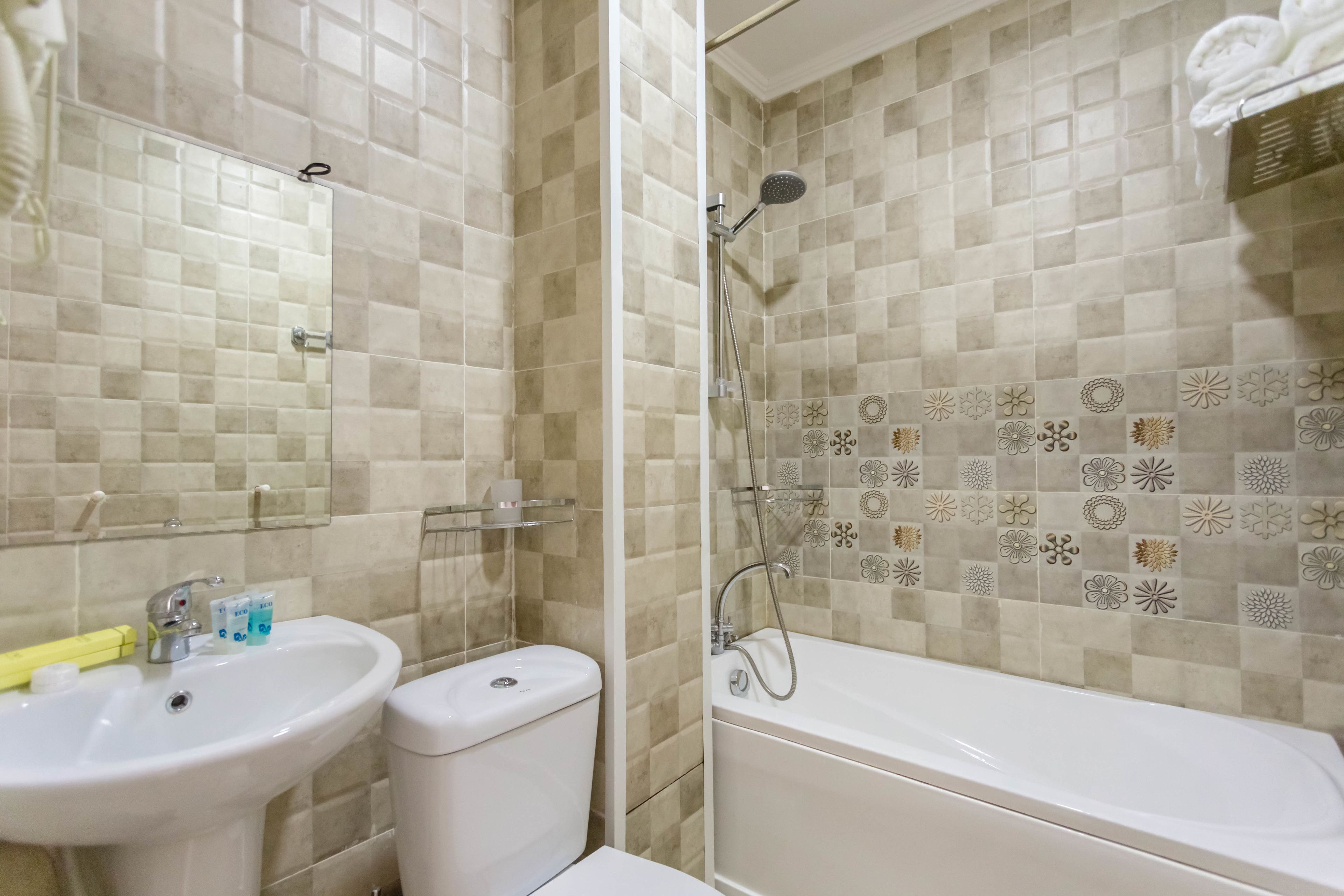 A bathroom with a sink, toilet, and bathtub.
