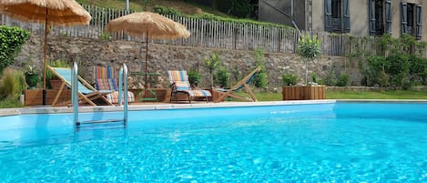 Seasonal outdoor pool, pool umbrellas, pool loungers