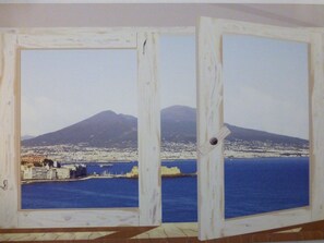 A view through a door with a cityscape and a mountain in the background. - Sotto le Stelle Ai Decumani (Naples)