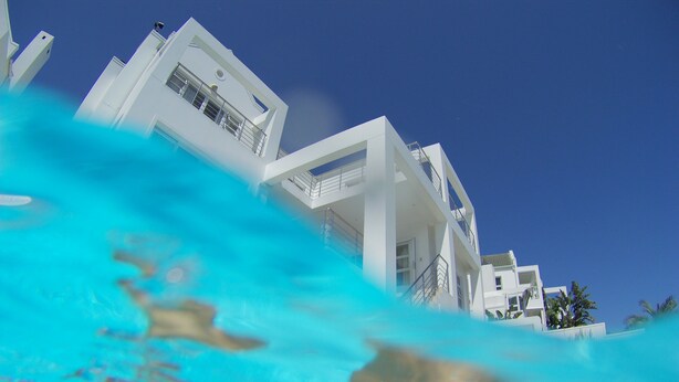 A modern white building with balconies and a clear blue sky. - Cape Town Kite Club (Cape Town)