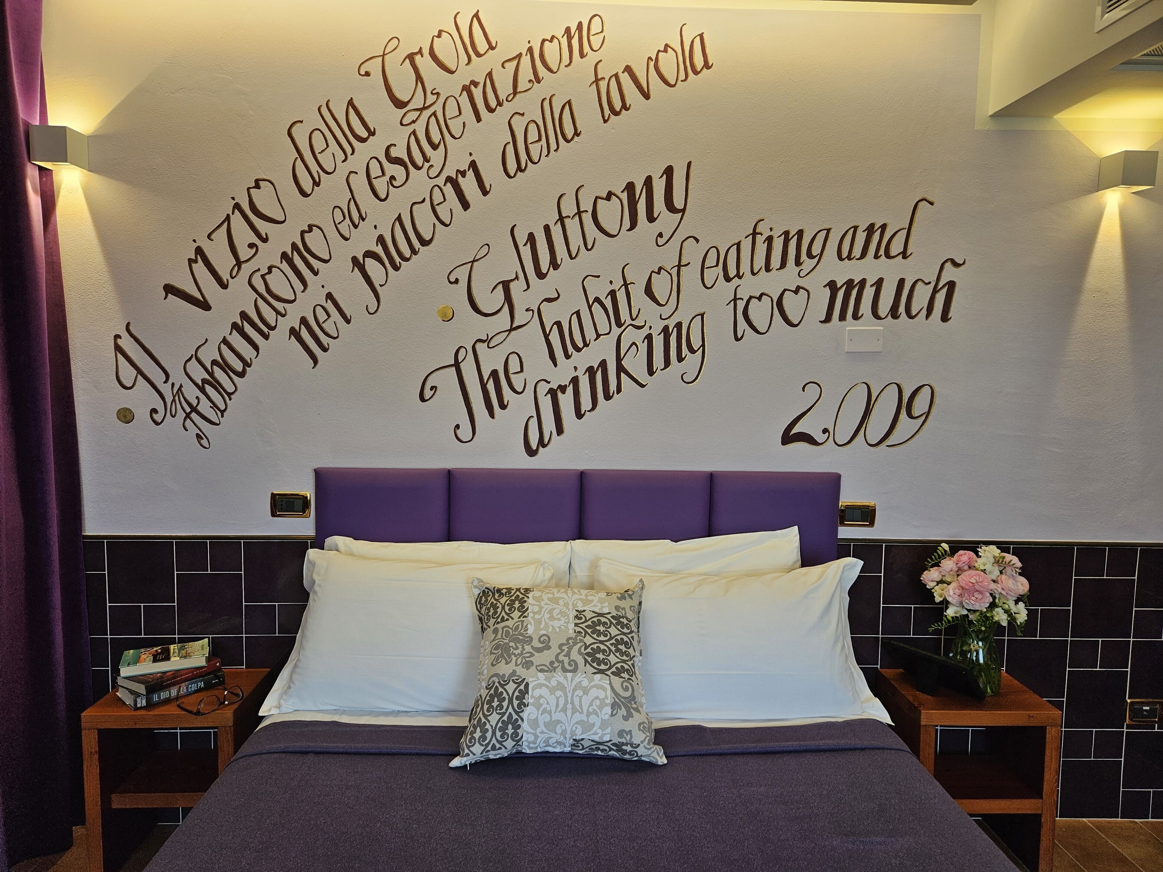 A bedroom with a large wall decal featuring motivational quotes and the year 2009.