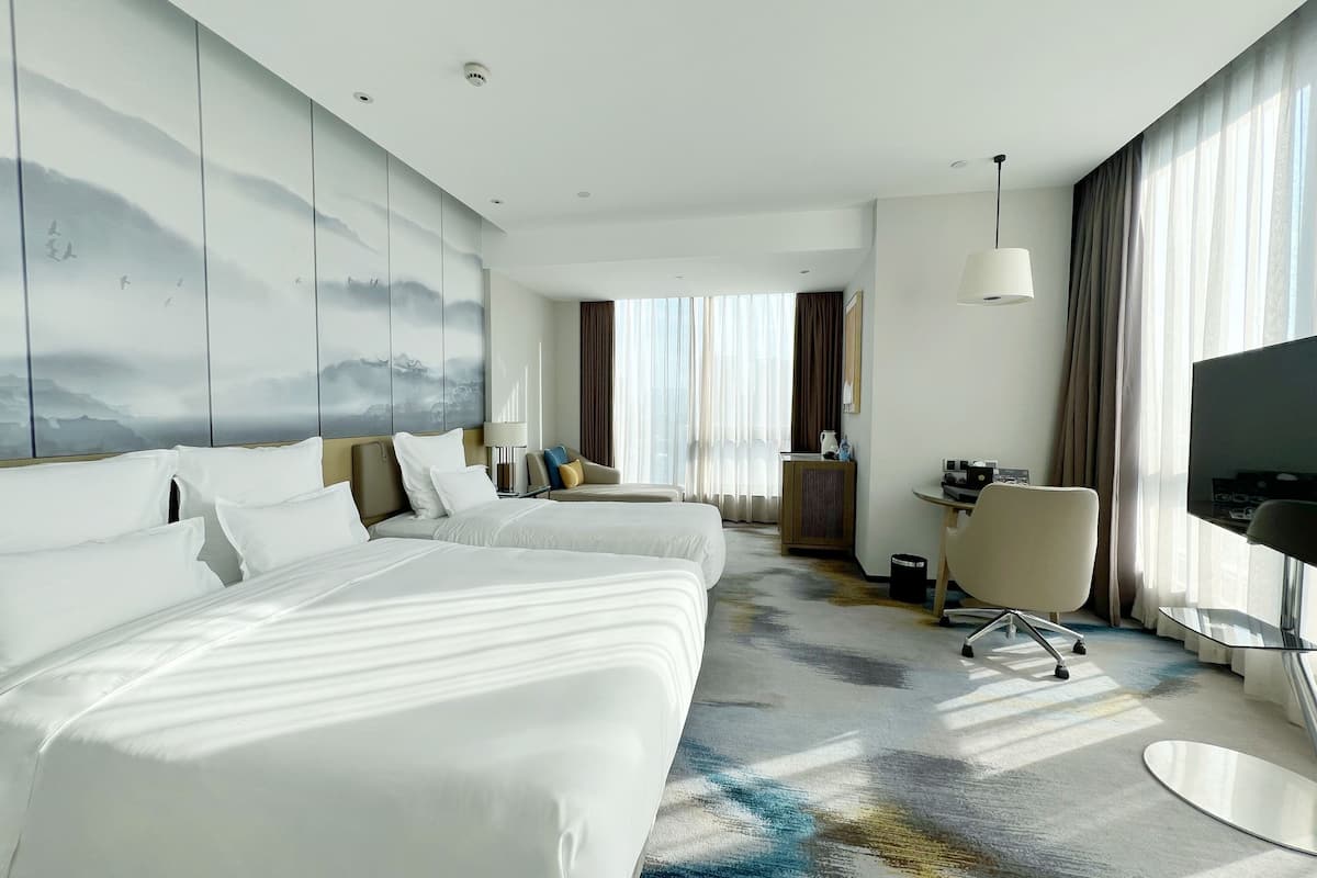 deluxe room, multiple beds, city view (premium) | 1 bedroom, minibar, in-room safe, individually decorated