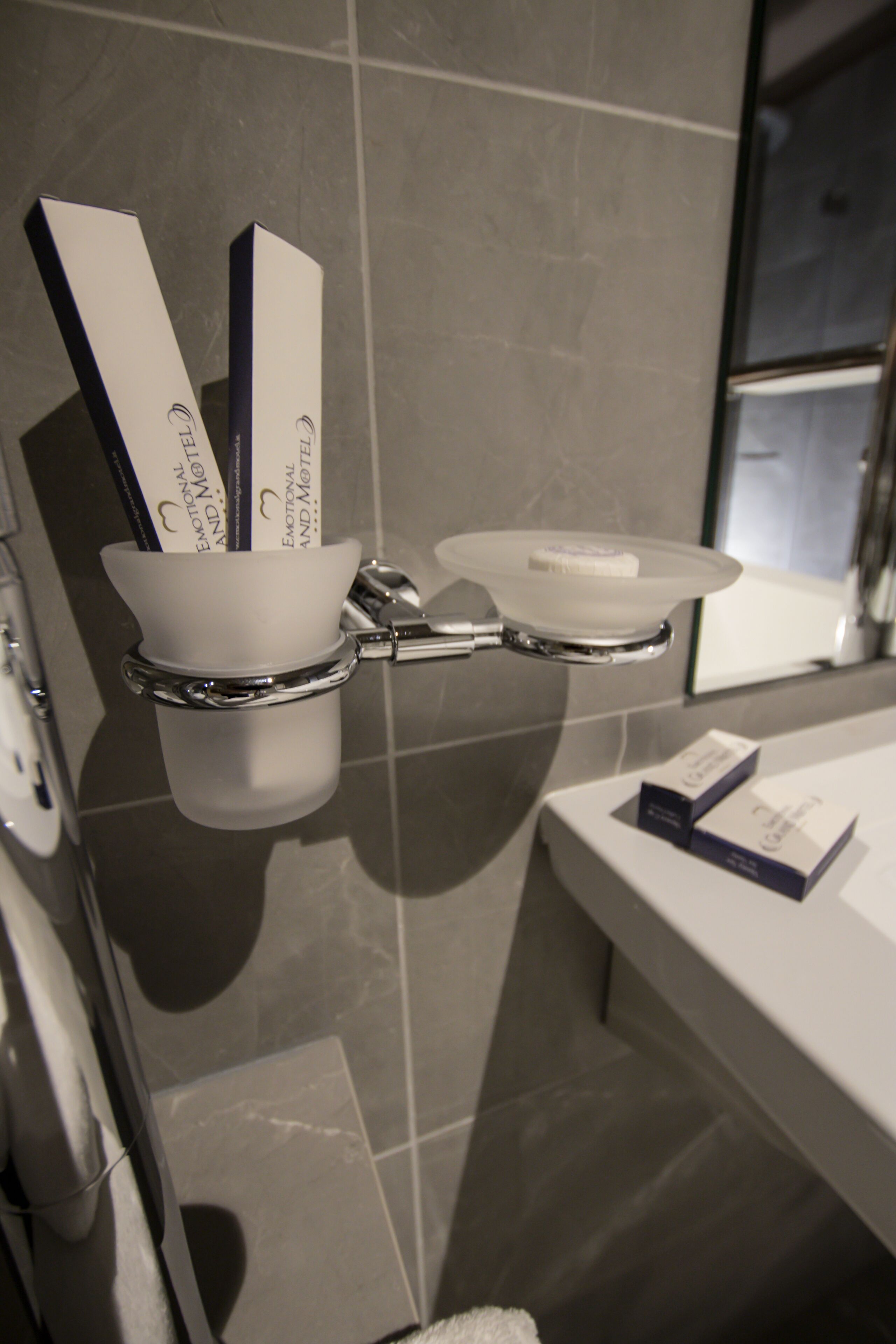 A modern bathroom with a toilet, bidet, and a glass shower enclosure.