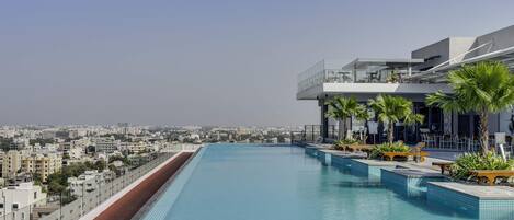 Outdoor pool, open 6:30 AM to 8:00 PM, pool umbrellas, pool loungers