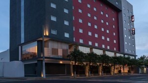 A modern hotel building with a prominent red and black facade, featuring the 'ibis' logo and 'HOTEL' signage. - ibis Mexico Tlalnepantla (Tlalnepantla de Baz)