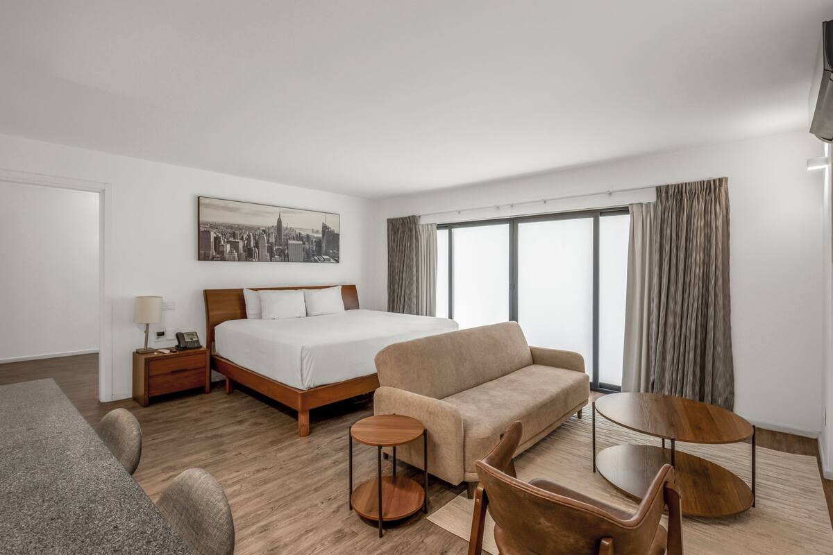 Deluxe Suite, 2 Bedrooms | Minibar, in-room safe, blackout drapes, iron/ironing board