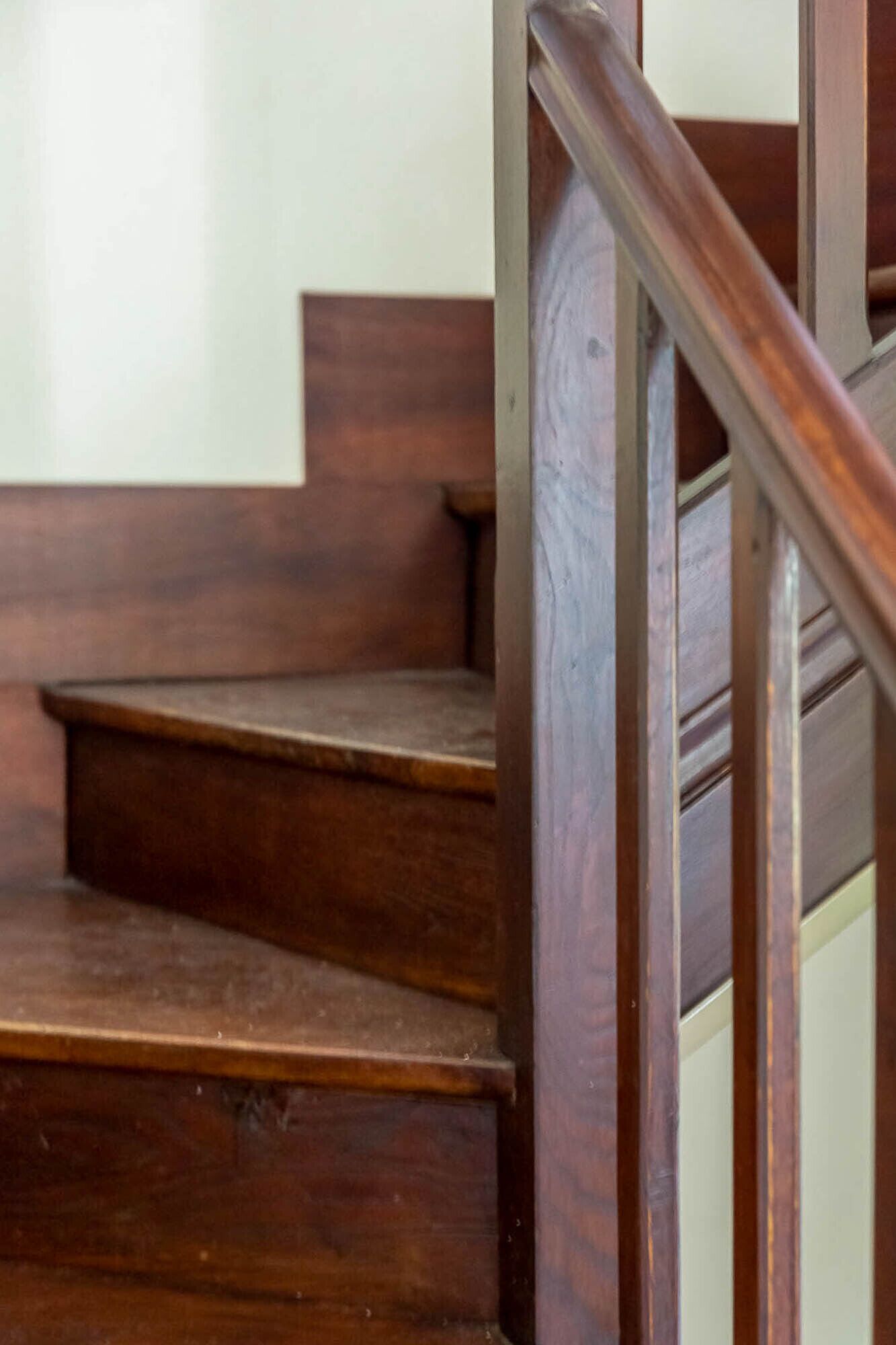 A wooden staircase with a handrail.