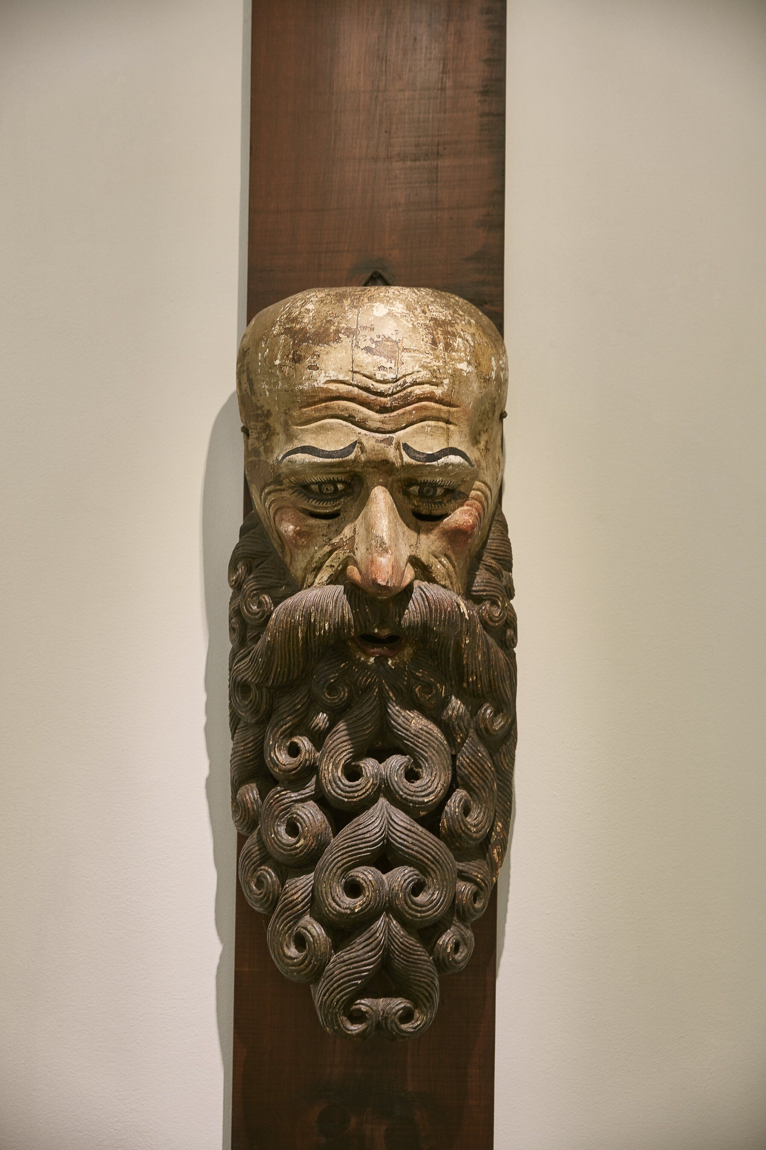 A carved wooden headpiece with intricate patterns.