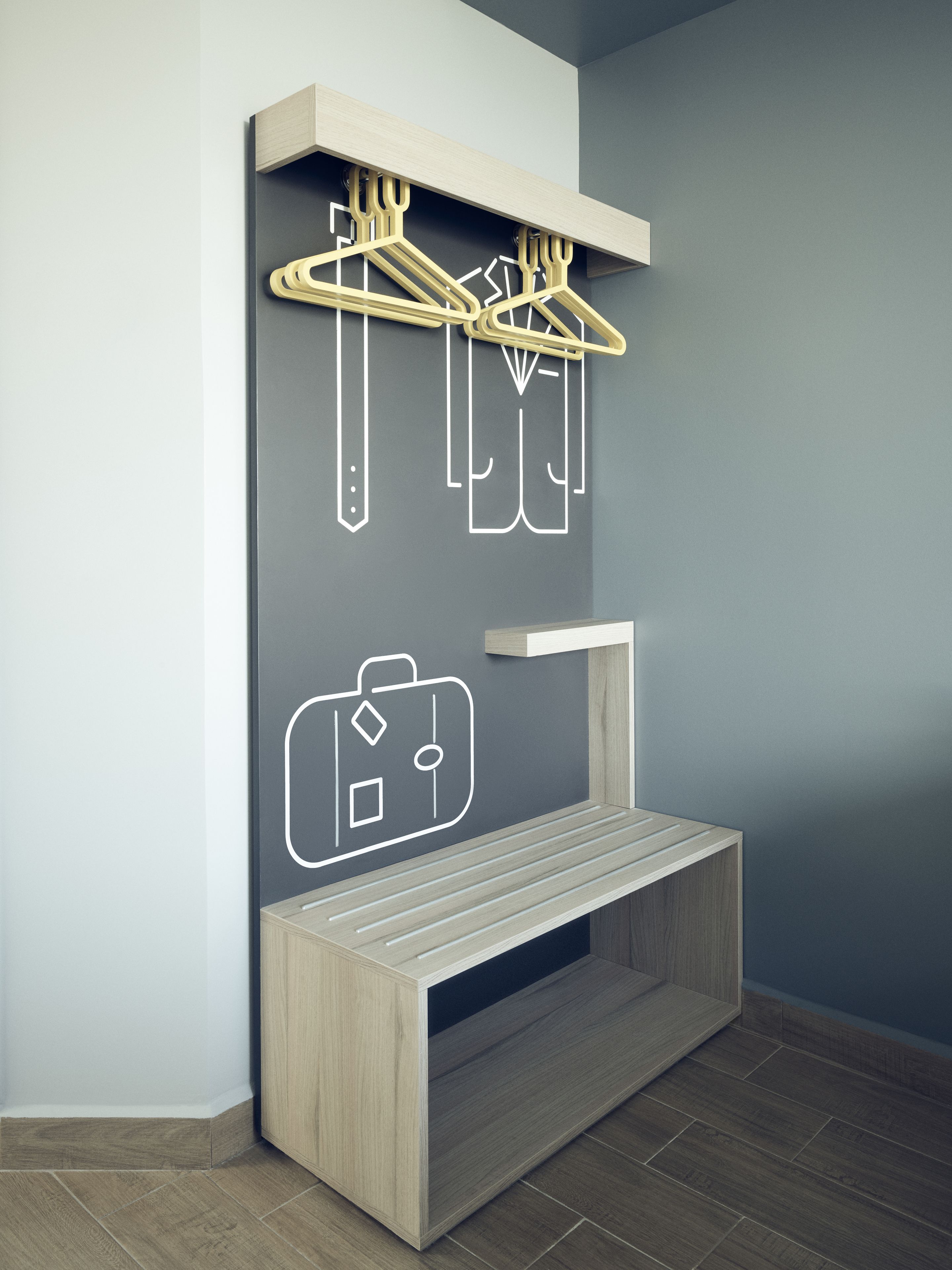 A modern room with a built-in wooden bench, a wall-mounted coat rack, and a minimalist design.
