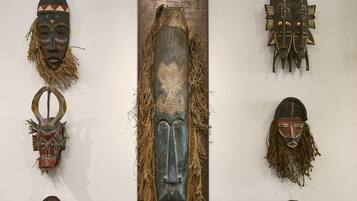 A collection of traditional masks displayed on a wall.