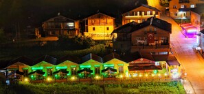 A hotel with multiple buildings, outdoor seating areas, and a visible sign for 'Cakir Keyf Cafe'. - Cakıroğlu Villa Kent (Çaykara)