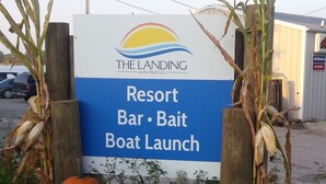 A sign for The Landing on the Wolf, LLC, advertising a Resort Bar, Bait, and Boat Launch. - The Landing on the Wolf (Winneconne)