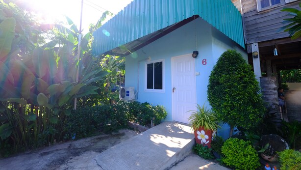 A house with a blue exterior, a white door, and a small porch area. - Huenhimphu Resort (Phu Phan)