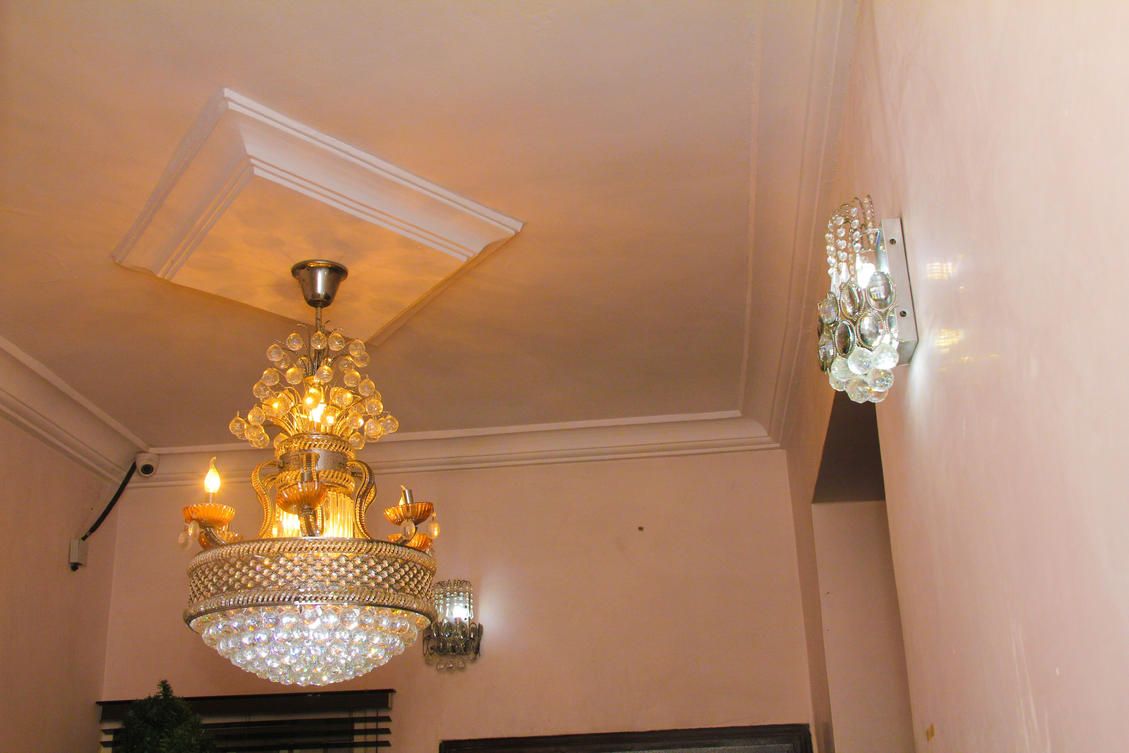 A chandelier with multiple lights and crystal decorations.