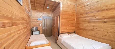 Deluxe Quadruple Room, Garden View | Minibar, bed sheets