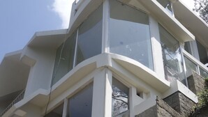A modern building with multiple balconies and large windows. A sign reads "Dunn Perk Manor." - Dunn Perk Manor (Solan)