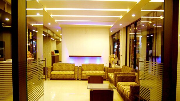 A modern living room with sofas, a coffee table, and a flat-screen TV.