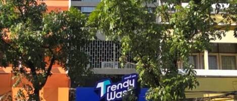 A building with a blue storefront labeled "Trendy Wash."