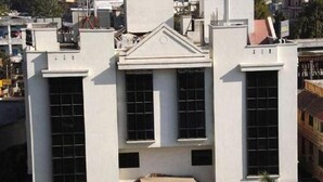 Un edificio moderno con facciata simmetrica, ampie finestre e un ingresso centrale.