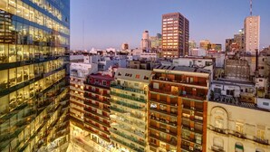A high-rise building with multiple floors, large windows, and balconies. - Nido x Bellini Esmeralda (Buenos Aires)