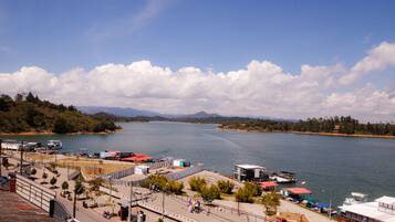 Zona ribereña con puerto deportivo, edificios y una carretera que lleva al agua.