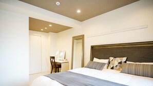 Une chambre avec un grand lit, un bureau et une chaise.