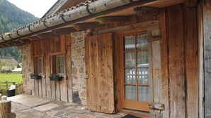 A rustic wooden cabin with stone walls and a wooden door. - Maso Franceschella (Ville di Fiemme)