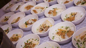 Multiple white bowls arranged on a table with a patterned tablecloth. - Heritage Journey Homestay (Hai Phong)