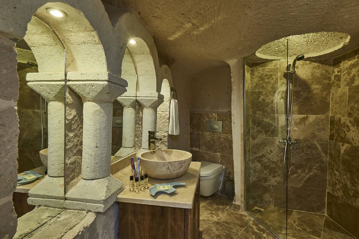 room (premier cave) | bathroom | shower, rainfall showerhead, hair dryer, slippers