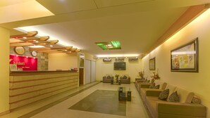 A hotel lobby with a reception desk, sofas, a coffee table, and a clock on the wall. - Bashati Bay Resort (Cox's Bazar)