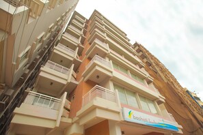 A multi-story building with balconies and a sign for 'Bashatti Bay Resort'.