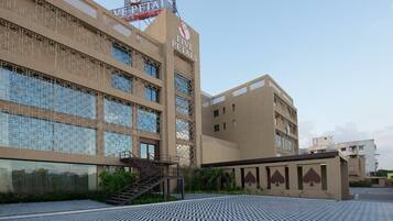 A hotel with a modern facade, a visible staircase, and a patterned floor.