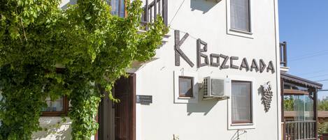 A white building with a sign reading "Kozcapa".